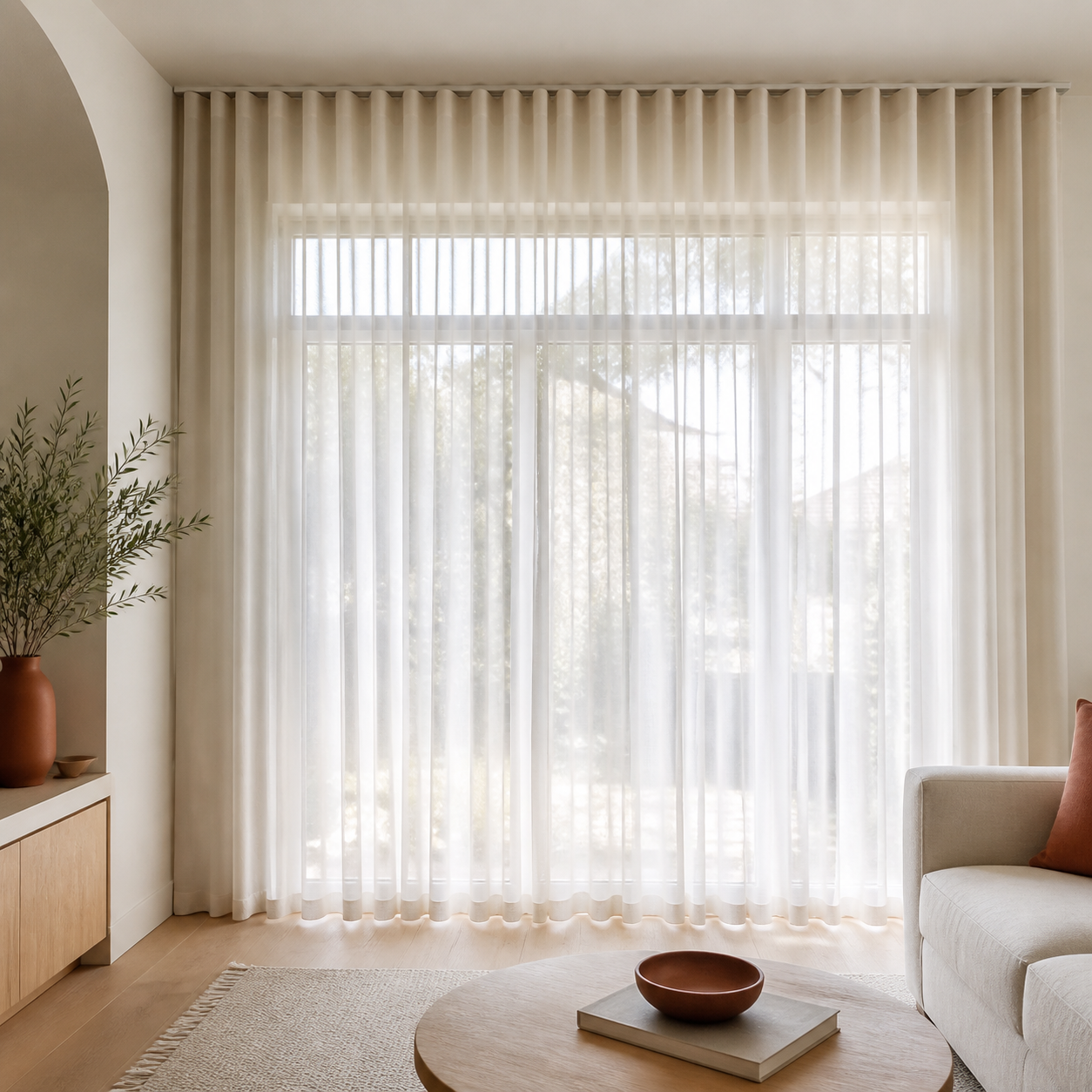 Full-height ivory sheer curtains filtering warm natural light